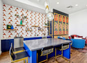 Thumbnail 30 of 41 - a dining room with a blue table and chairs