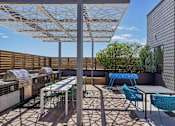 Thumbnail 26 of 41 - a patio with tables and chairs and a pergola