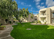 Thumbnail 20 of 21 - an apartment building with green grass and trees