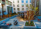 Thumbnail 26 of 30 - a courtyard with a table and chairs in front of a building