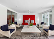 Thumbnail 20 of 24 - A living room with a red backdrop and white furniture.
