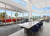 Thumbnail 18 of 24 - A large conference room with a long table and chairs.
