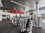 Thumbnail 21 of 24 - A gym with a variety of equipment including treadmills, weights, and exercise machines.