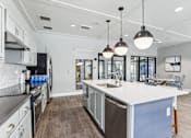 Thumbnail 21 of 32 - a large kitchen with an island and stainless steel appliances