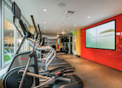 Thumbnail 11 of 24 - fitness center with cardio equipment and a large window