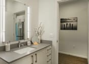 Thumbnail 6 of 24 - a bathroom with a large mirror and a sink