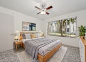 Thumbnail 12 of 24 - a bedroom with a bed and a ceiling fan