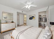 Thumbnail 14 of 24 - a bedroom with a large bed and a ceiling fan