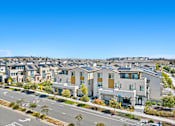 Thumbnail 19 of 20 - A row of modern houses with a road in front of them.