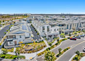 Thumbnail 18 of 20 - A residential area with houses and a road with cars.