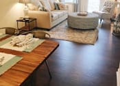 Thumbnail 19 of 19 - A living room with a couch, chair, and table.