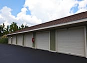 Thumbnail 9 of 19 - A long row of garage doors with one red and one green.