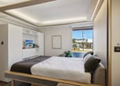 Thumbnail 8 of 26 - a bedroom with a bed and a window
