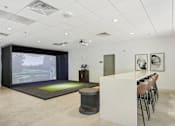 Thumbnail 25 of 26 - a room with a bar and a projection screen on the wall