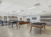 Thumbnail 16 of 26 - a game room with two pool tables and a bar