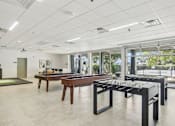 Thumbnail 15 of 26 - a game room with a foosball table and ping pong