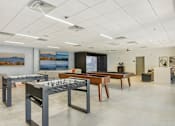 Thumbnail 5 of 26 - a conference room with tables and chairs and paintings on the wall