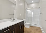 Thumbnail 10 of 53 - A white bathroom with a toilet, sink, and shower.