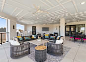Thumbnail 52 of 53 - A modern outdoor living space with a white ceiling fan and a black and white striped rug.