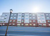 Thumbnail 38 of 53 - a building with the sun shining in front of it