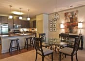 Thumbnail 2 of 18 - a dining room and kitchen with a table and chairs