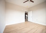 Thumbnail 19 of 53 - an empty living room with white walls and a ceiling fan