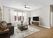 Thumbnail 3 of 53 - A living room with a couch, a coffee table, and a television.