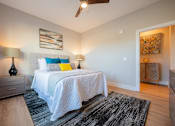 Thumbnail 40 of 53 - a bedroom with a bed and a ceiling fan