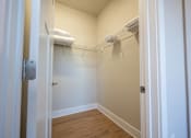Thumbnail 39 of 53 - a walk in closet with a mirrored closet door and a wire rack