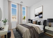 Thumbnail 6 of 8 - A bedroom with a large bed and a painting on the wall.