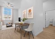 Thumbnail 3 of 8 - A dining room with a table and chairs.