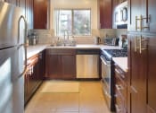 Thumbnail 12 of 64 - Apartment kitchen with stainless steel appliances and built-in cabinets