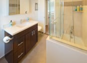 Thumbnail 13 of 64 - Apartment bathroom with vanity, shower tub combo