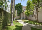 Thumbnail 26 of 64 - Apartment building courtyard with lush landscaping
