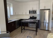 Thumbnail 54 of 64 - Apartment kitchen, dining area with built-in cabinets and stainless steel appliances