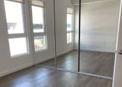 Thumbnail 56 of 64 - Apartment bedroom with mirrored closet doors