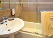 Thumbnail 23 of 64 - Apartment bathroom with vanity and shower tub combo