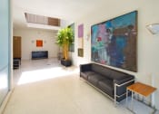 Thumbnail 36 of 64 - Apartment entry lobby with lush landscaping and artwork