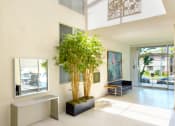 Thumbnail 35 of 64 - Apartment entry lobby with lush landscaping and artwork
