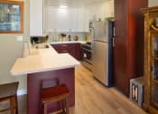 Thumbnail 31 of 64 - Apartment dining area and kitchen with appliances and built-in cabinets