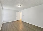 Thumbnail 24 of 33 - A room with a light brown floor and a white ceiling with a light fixture.