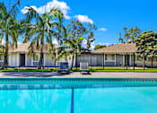 Thumbnail 13 of 31 - Swimming pool with lounge chairs and fencing at Coventry Square Apartments, Upland, 97186