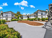 Thumbnail 10 of 33 - A residential area with houses and a curved driveway.