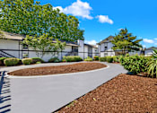Thumbnail 3 of 33 - A residential area with houses and a curved driveway.