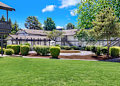 Thumbnail 5 of 33 - A large building with a lawn in front of it.
