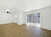 Thumbnail 20 of 31 - Open living area with kitchen and patio access at Coventry Square Apartments, Upland, 97186