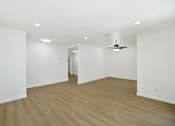 Thumbnail 19 of 31 - Spacious living room with wood style flooring at Coventry Square Apartments, Upland, California