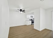 Thumbnail 25 of 31 - Open living and dining area with ceiling fan at Coventry Square Apartments, Upland