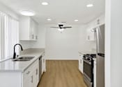 Thumbnail 30 of 31 - Bright galley kitchen with modern finishes at Coventry Square Apartments, Upland