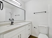 Thumbnail 26 of 31 - Bathroom with white vanity and subway tile shower at Coventry Square Apartments, California
